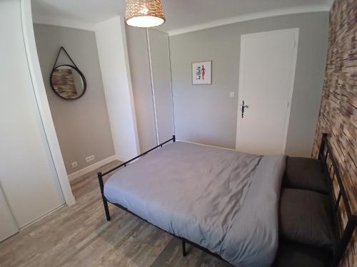 a bedroom with a bed and a couch in it at Chez lydie et jeff in Laudun