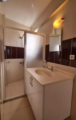 a bathroom with a sink and a shower at Begonvil Otel in Emin Sitesi