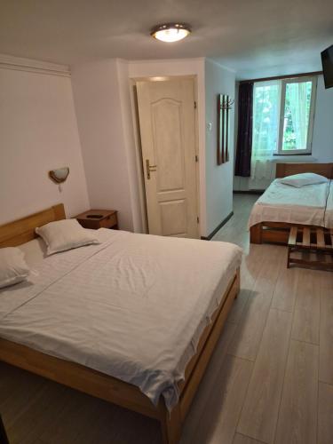 a bedroom with two beds and a door in it at VILA SZOKE SOVATA in Sovata