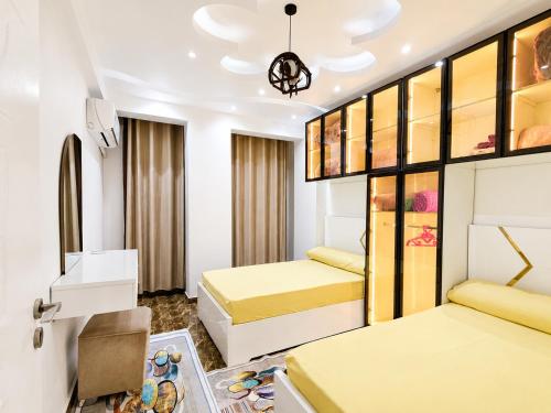 a hotel room with two beds and a sink at شقة مميزة بجوار كورنيش النيل اسوان - عائلات فقط in Aswan