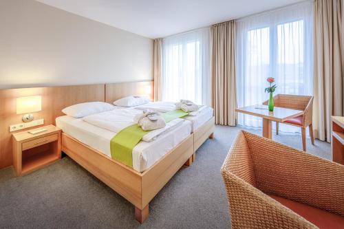 a bedroom with a large bed in a room at Hotel St Elisabeth in Allensbach