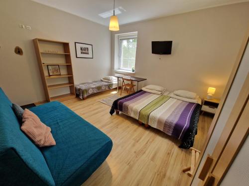 a living room with a bed and a couch at CasaBlanca Biały Dom in Borne Sulinowo
