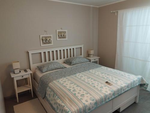 a bedroom with a bed and two night stands at Holiday house Altea , Barbat on the Island Rab in Rab