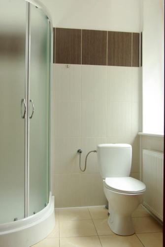 a bathroom with a toilet and a glass shower at CasaBlanca Biały Dom in Borne Sulinowo