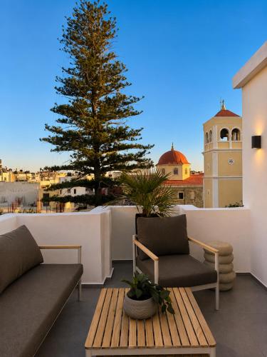 a patio with a tree on the roof of a building at Cabana Condo in Ierapetra