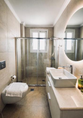 a bathroom with a shower and a toilet and a sink at Nefeli's apartment in Vonitsa