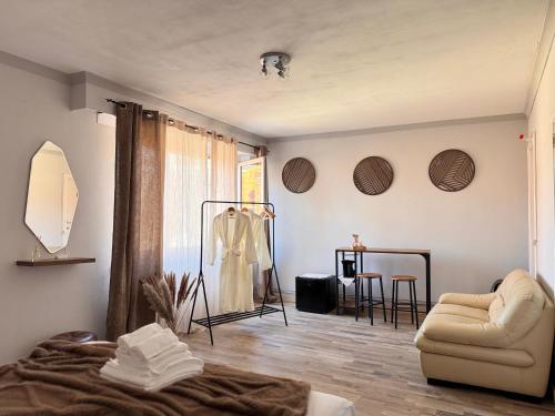 a living room with a bed and a chair at Maison Rosé in Hasselt
