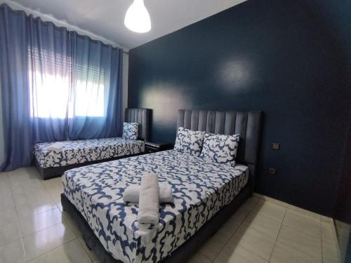 a bedroom with a bed and a chair in it at heartofrabat in Rabat