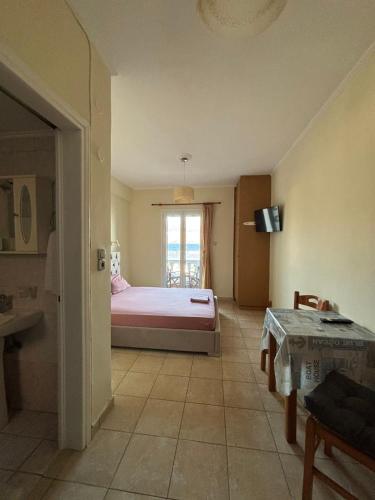 a bedroom with a bed and a window in it at Karyatis studios lixouri in Lixouri