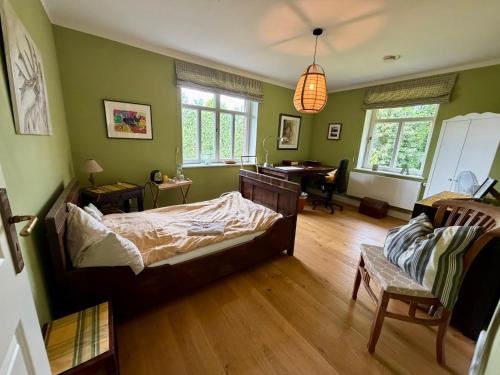 a bedroom with a bed and a desk in it at EinfachSein Zimmer in Trittau