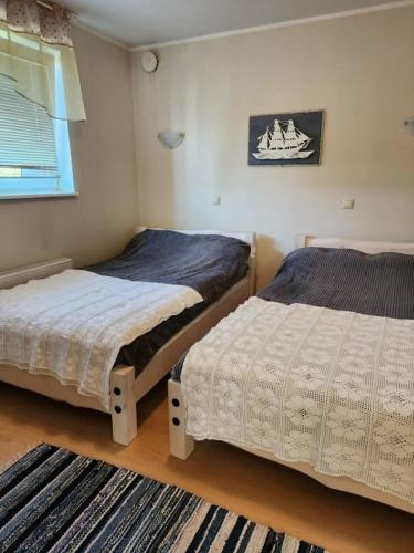 a bedroom with two beds and a window at Tähe Holiday Home in Pärnu