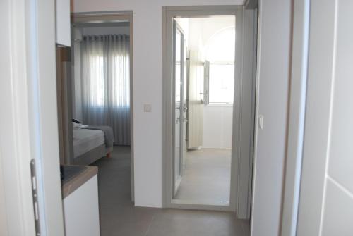 a room with a mirror and a bedroom with a bed at Busho Residence 2 in Naousa