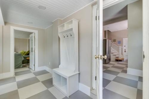 a hallway with white walls and a checkered floor at 2-Unit Bundle in Eustis: Walk to Ferran Park! in Eustis