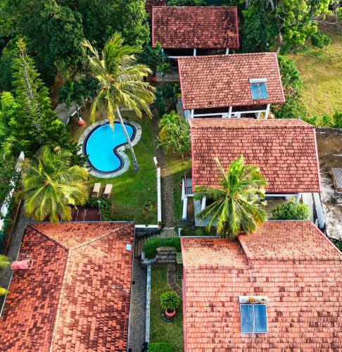 an aerial view of a house with a swimming pool at New Moonstone Tangalle in Tangalle