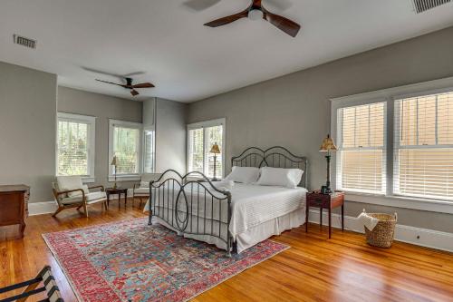 a bedroom with a bed and a table and windows at 2-Unit Bundle in Eustis: Walk to Ferran Park! in Eustis