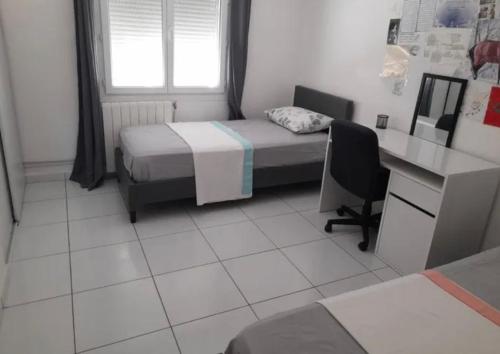 a bedroom with a bed and a desk and a desk at Maison de vacance Montpellier in Montpellier