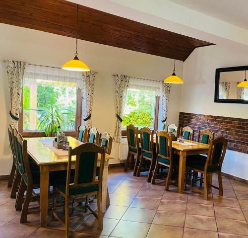a dining room with wooden tables and chairs at Restaurace Staré Sedlo in Orlík