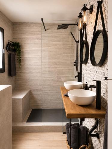 a bathroom with two sinks and a shower at Villa Otivar - Rio Verde in Otívar