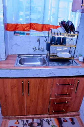 a kitchen counter with a sink and a window at Kakamega bransoncomfort in Kakamega