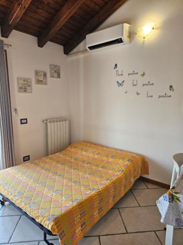 a bedroom with a bed and a air conditioner on the wall at MXP apartment, shuttle service, parking free in Cardano al Campo
