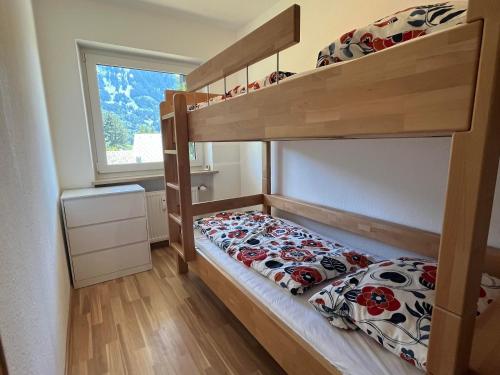 a small bedroom with a bunk bed and a window at Ferienwohnung Heid in Rettenberg