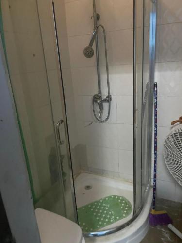a shower with a glass door in a bathroom at Hotel Mardoche Banto in Luanda