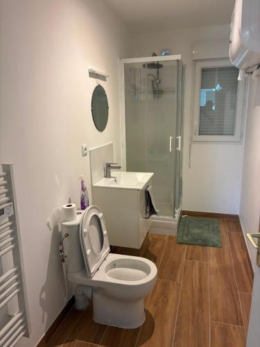 a bathroom with a toilet and a sink and a shower at NovaStay in Breuillet