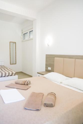 a bedroom with two beds with towels on them at Rasi Luxury Apartments in Ulcinj