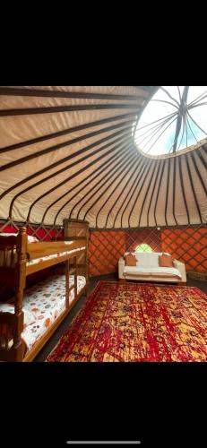 a room with a roof with a bed and a rug at Hillside Retreats in Machynlleth