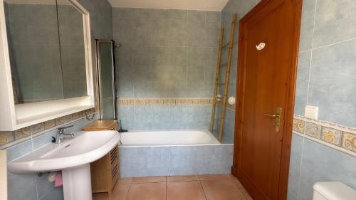 a bathroom with a sink and a bath tub at 6 person house with private pool and garden in Trebeluger