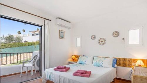 a bedroom with a bed and a balcony at Apartment for 6 with a private terrace in Son Bou in Son Bou