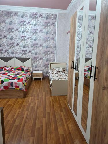 a bedroom with a bed and a wall with a mural at Anna's Guesthouse in Kobuleti