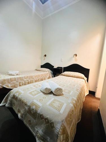 a bedroom with two beds with towels on them at Hotel Selby in San Juan