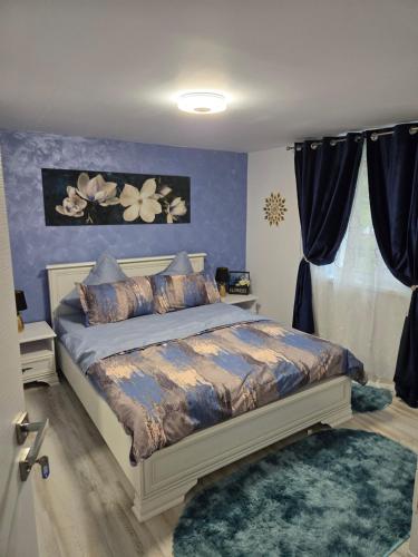 a bedroom with a bed with a blue wall at Casa Valor in Lacu Rosu
