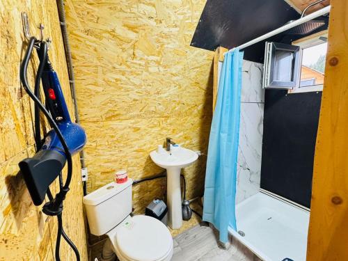 a small bathroom with a toilet and a sink at Aalam ordo in Shabdan