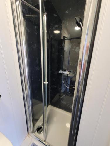 a shower with a glass door in a bathroom at The Bugle Hotel in Titchfield