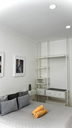 a white room with a bed and a tv at HOME City Stay Chemnitz in Chemnitz