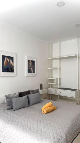 a white bedroom with a large bed with a window at HOME City Stay Chemnitz in Chemnitz