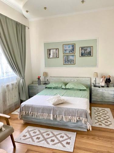 a bedroom with a large bed and a window at Parasolka in Odesa