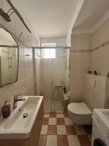 a bathroom with a sink and a toilet and a shower at Thama Poros in Poros