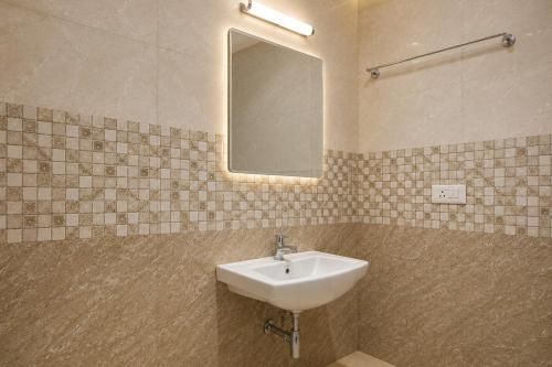 a bathroom with a sink and a mirror at Hotel Not Dot in north GOA in Calangute