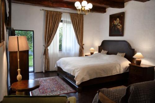 a bedroom with a large bed and a window at Casa Huber in Cîrţa