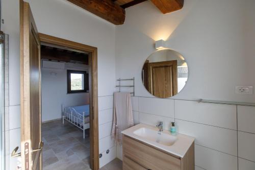 a bathroom with a sink and a mirror at Peaceful Umbria views & heated infinity pool in Umbertide