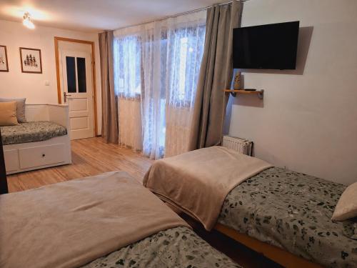a hotel room with two beds and a window at Kuća za odmor Lipa Dora near Plitvice in Donji Babin Potok