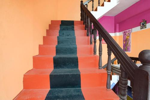 a stairway with colorful steps in a house at Hotel O SSR residency in Venjāramūdu