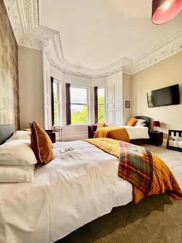 a large bedroom with two beds and a tv at Scot Townhouse in Edinburgh
