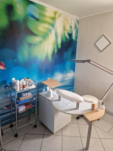 a room with a desk and a chair and a painting at Relax Ferienwohnung in Odernheim