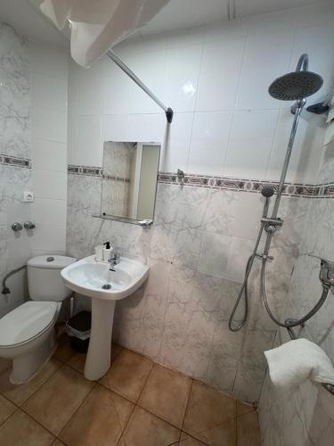 a bathroom with a toilet and a sink and a shower at COLIBRI in Calella