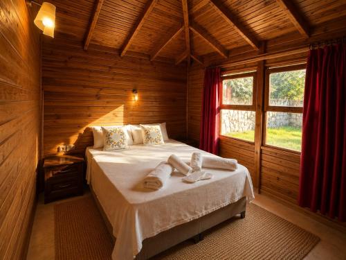 a bedroom with a bed in a wooden room at Denge Hidden Garden in İslâmlar