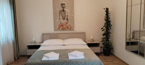 a bedroom with a bed with two towels on it at Apartmani Novosel in Šilo